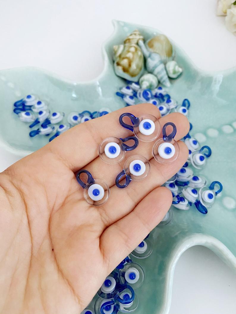 Five clear Murano glass evil eye beads, each 15mm in size, featuring a protective charm design.