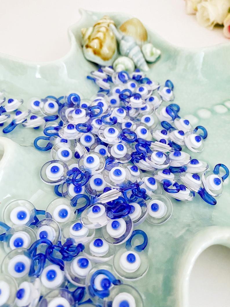 Five clear Murano glass evil eye beads, each 15mm in size, featuring a protective charm design.