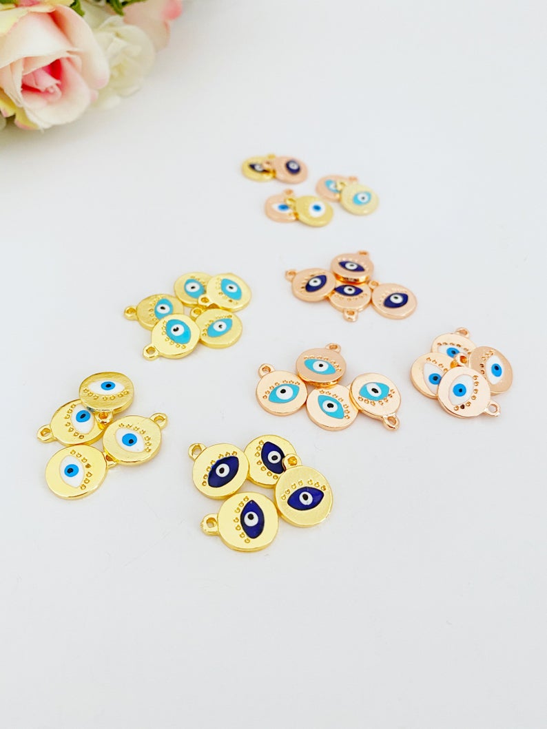 Five rose gold evil eye charms with customizable eye colors, perfect for jewelry making.