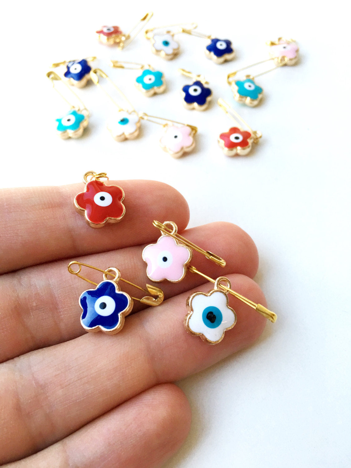 Set of 5 colorful Evil Eye safety pins with four leaf clover design, gold plated and enamel finish, perfect for baby protection.