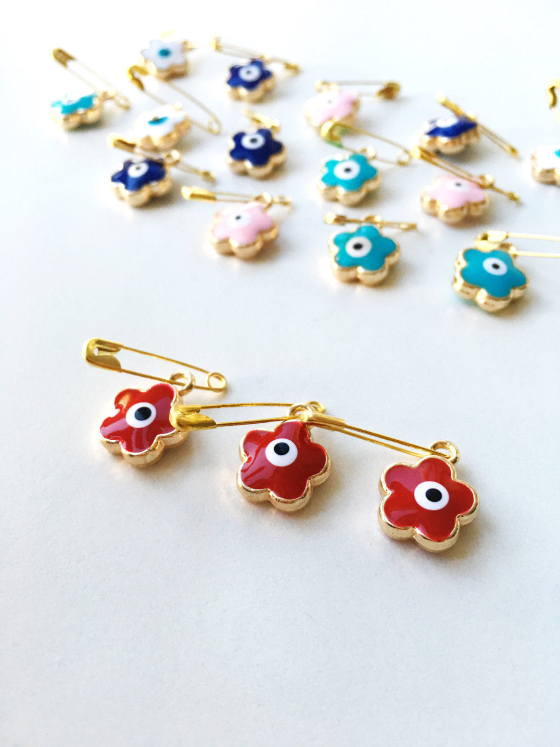 Set of 5 colorful Evil Eye safety pins with four leaf clover design, gold plated and enamel finish, perfect for baby protection.