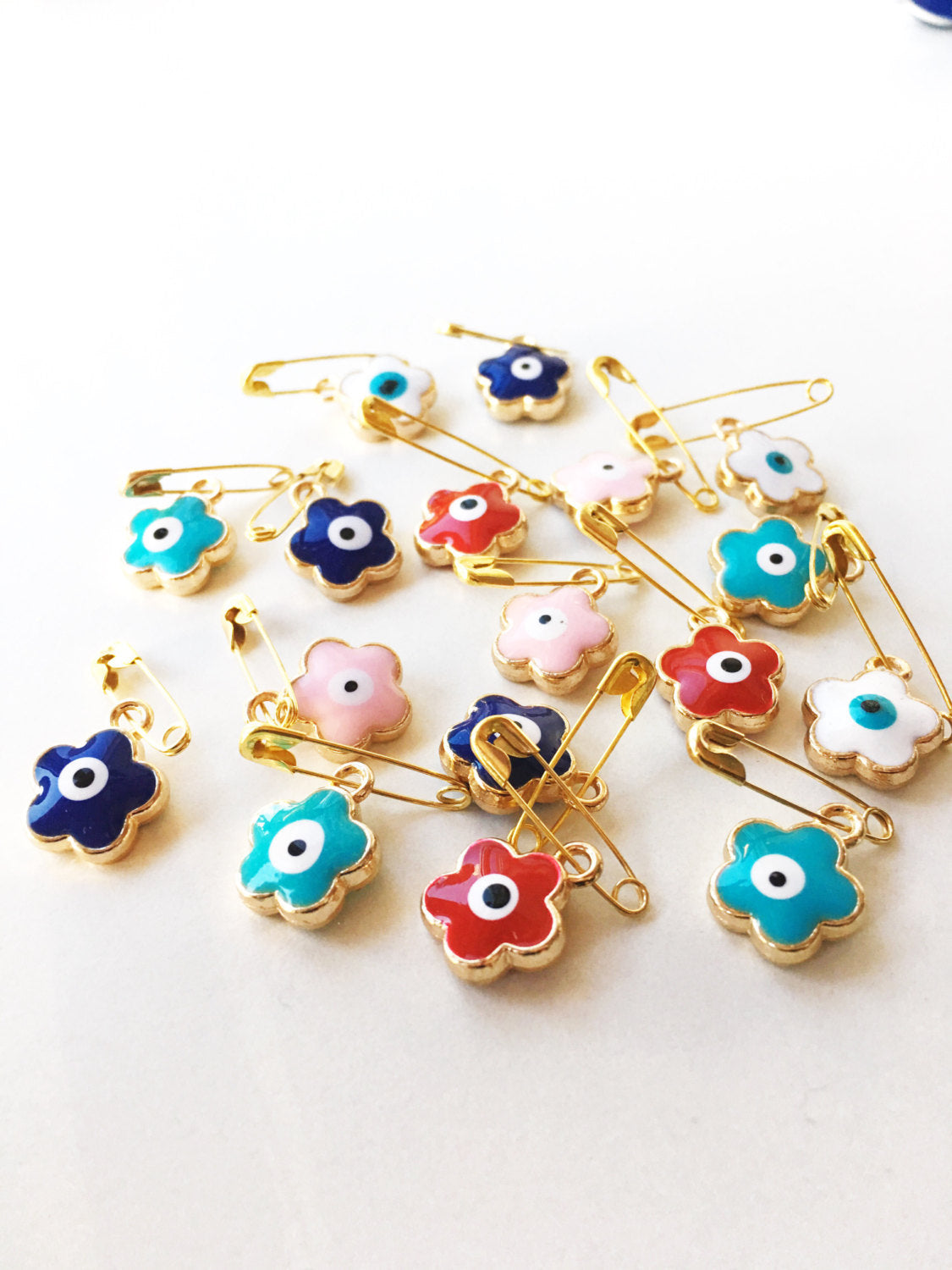 Set of 5 colorful Evil Eye safety pins with four leaf clover design, gold plated and enamel finish, perfect for baby protection.