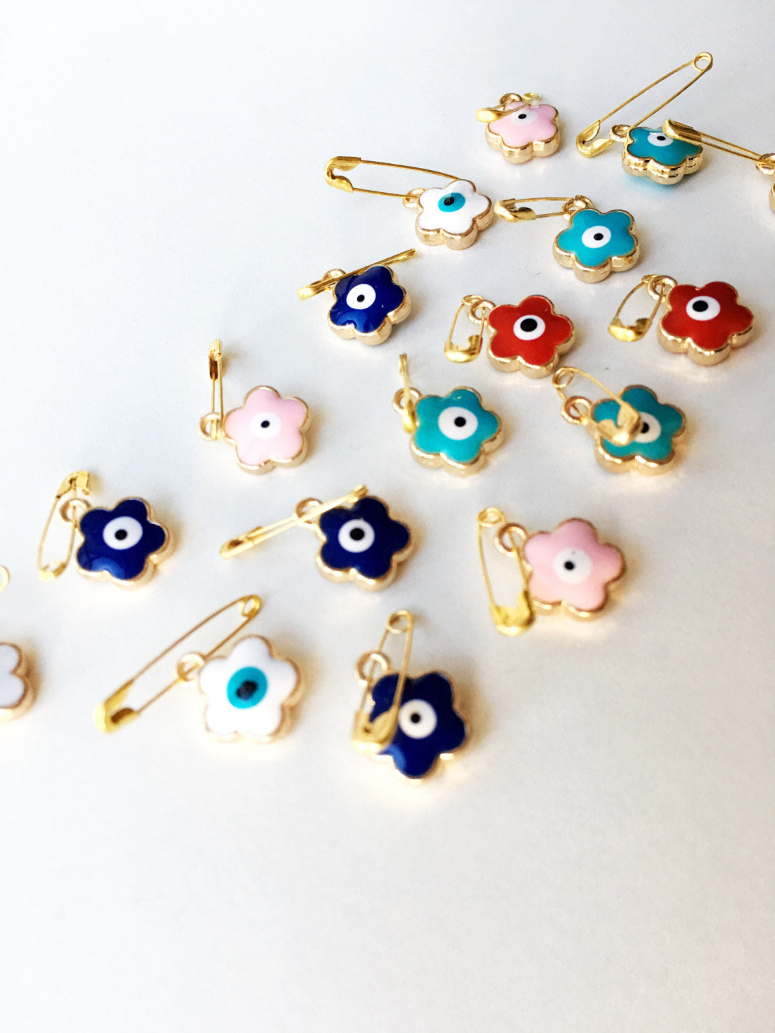 Set of 5 colorful Evil Eye safety pins with four leaf clover design, gold plated and enamel finish, perfect for baby protection.