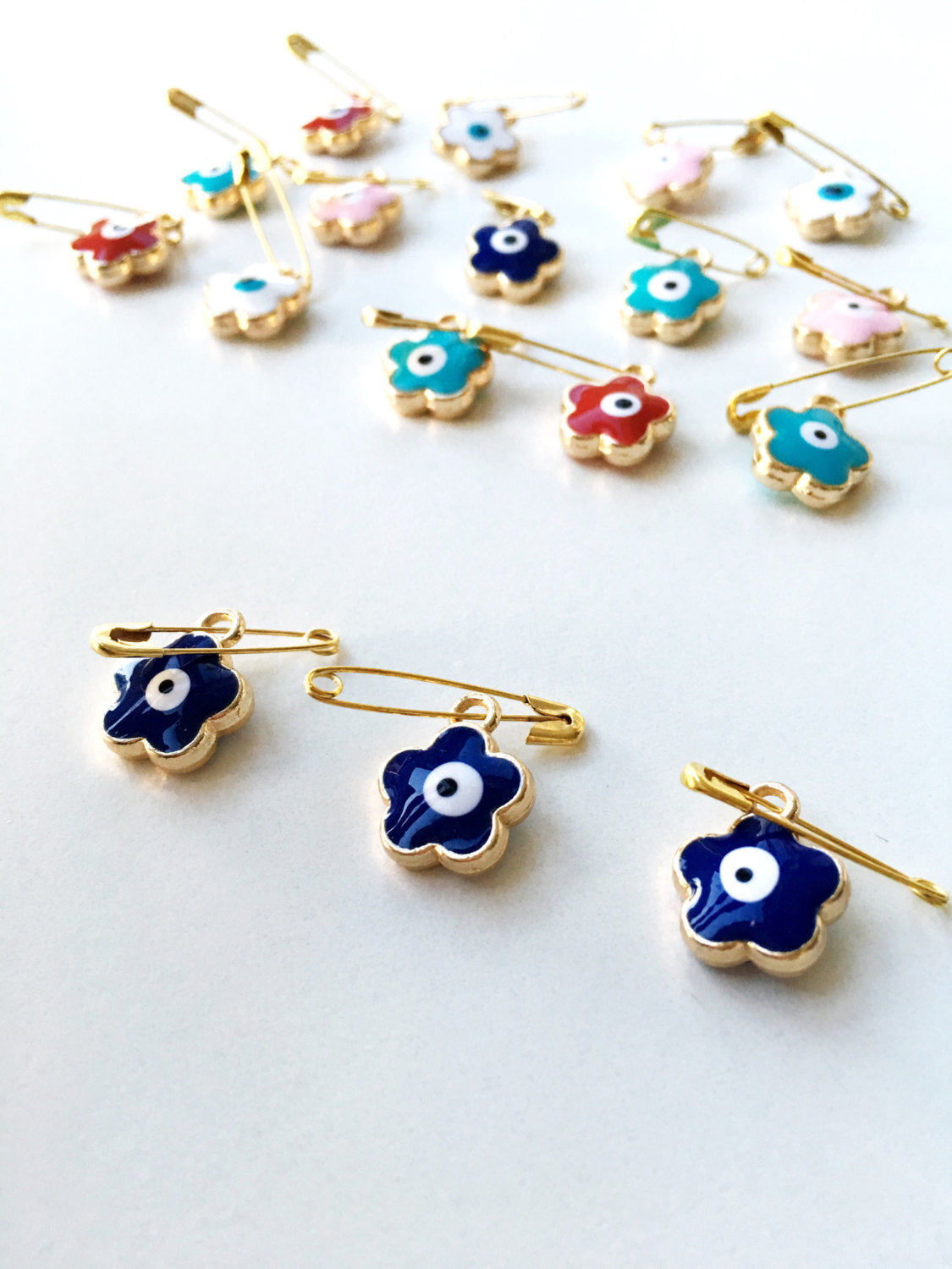 Set of 5 colorful Evil Eye safety pins with four leaf clover design, gold plated and enamel finish, perfect for baby protection.