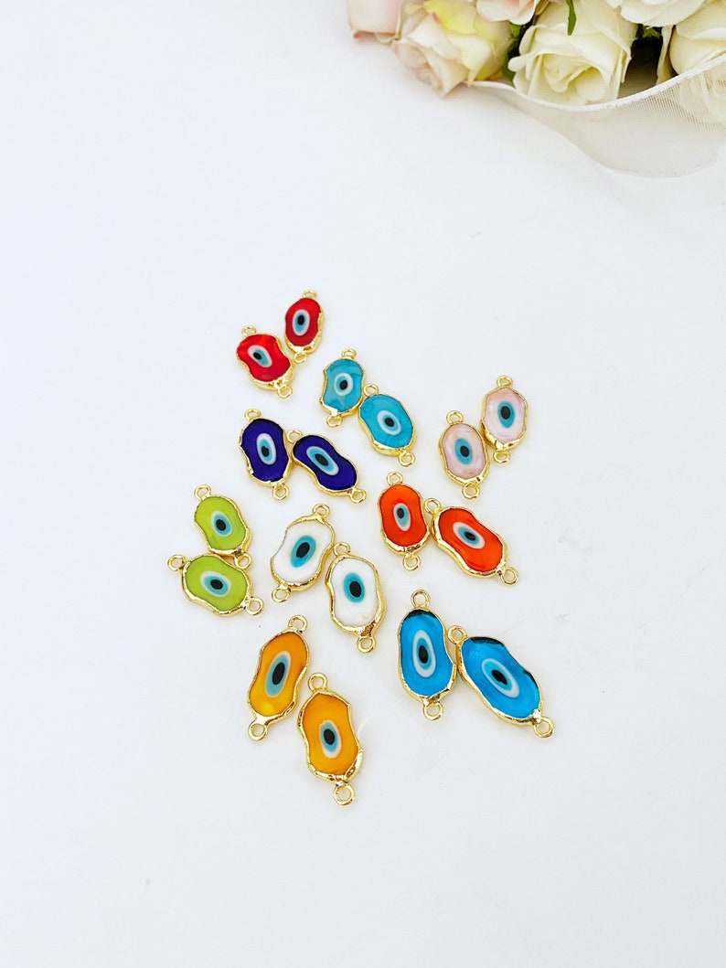 Five handmade green Murano glass evil eye beads with gold accents, ideal for jewelry making.