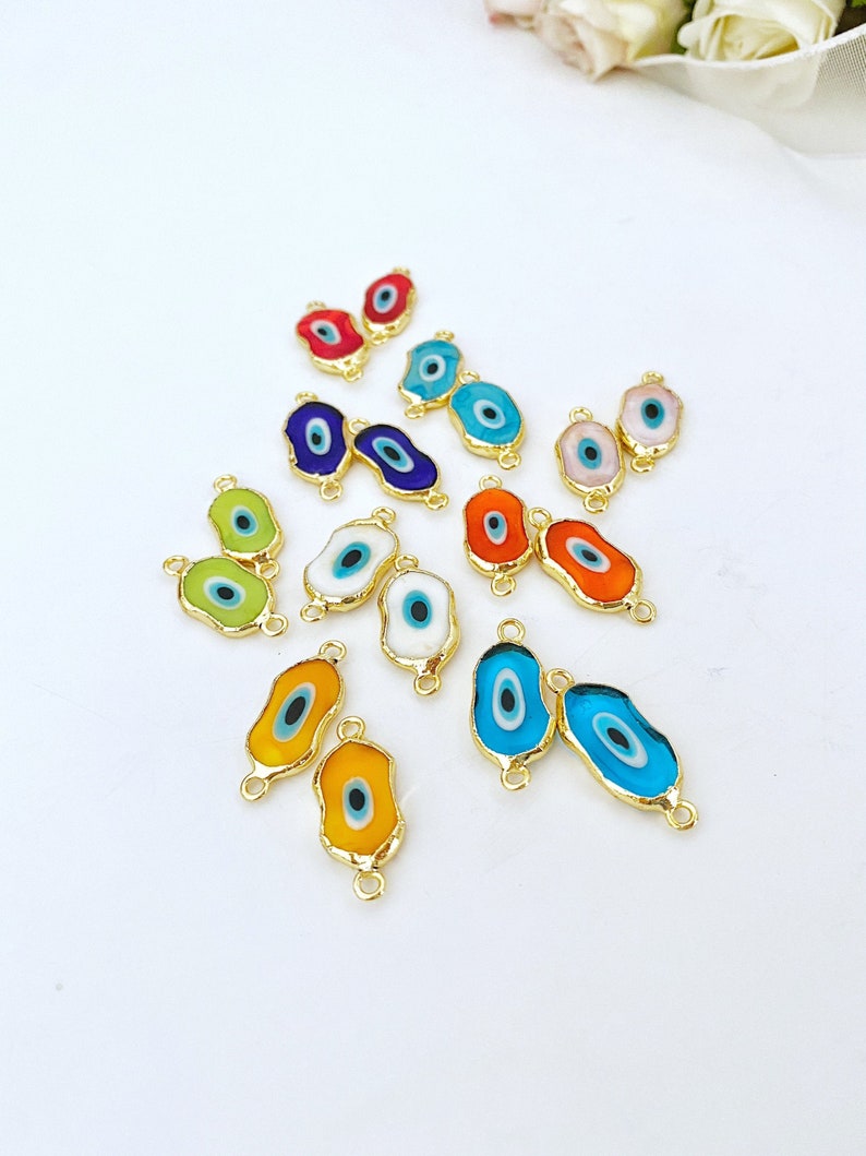 Five handmade green Murano glass evil eye beads with gold accents, ideal for jewelry making.