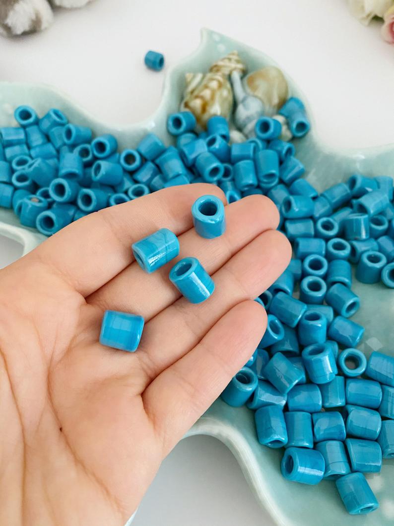 Five handmade Murano glass beads in blue, featuring large holes for easy threading, perfect for jewelry making.