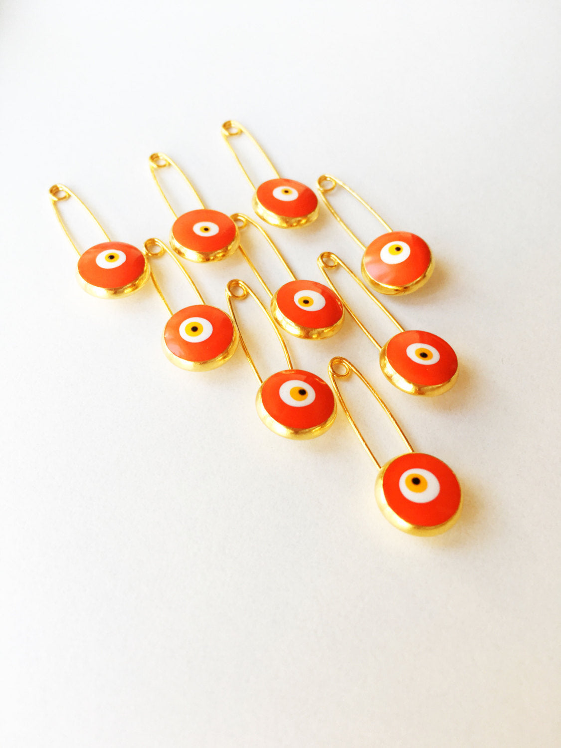 Five gold plated lucky evil eye safety pins in various colors, designed for baby protection and style.