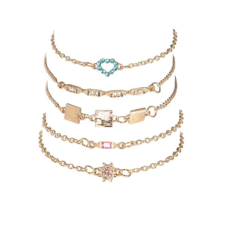 A stylish 5 piece bracelet set featuring cute and kitschy designs with colored crystals, elegantly plated in 14K gold.