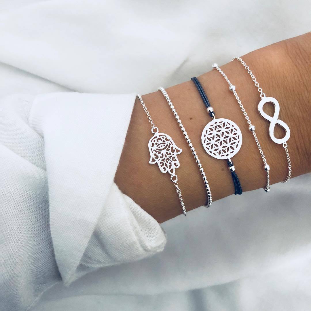 5 Piece Hamsa Infinity Bracelet Set in 18K white gold plating, showcasing intricate designs and a comfortable fit.