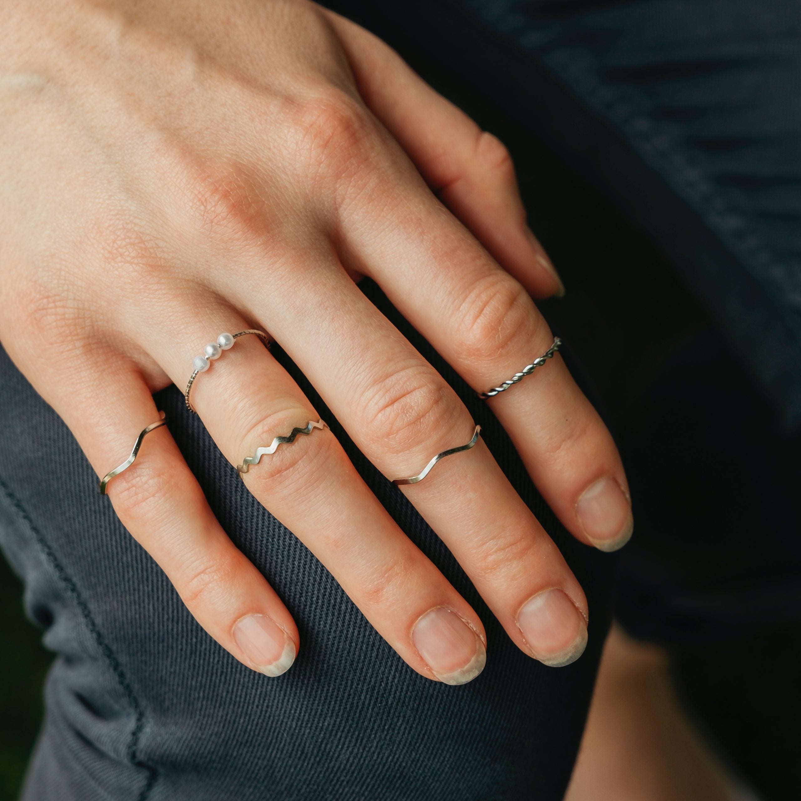 5 Piece Slim Silver Gold Stackable Midi Pearl Ring Set displayed elegantly, showcasing the rings' minimalist design and bohemian style.