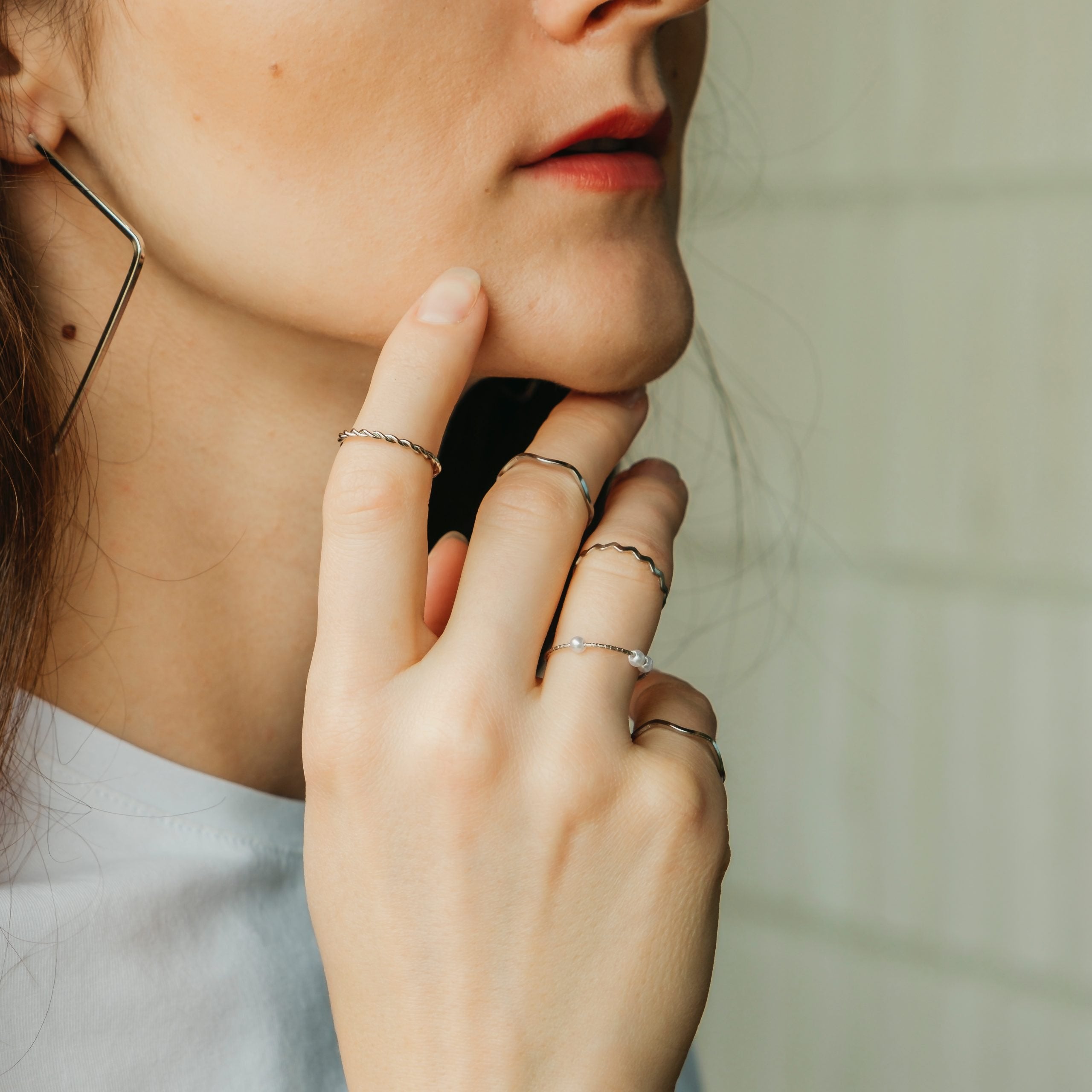 5 Piece Slim Silver Gold Stackable Midi Pearl Ring Set displayed elegantly, showcasing the rings' minimalist design and bohemian style.