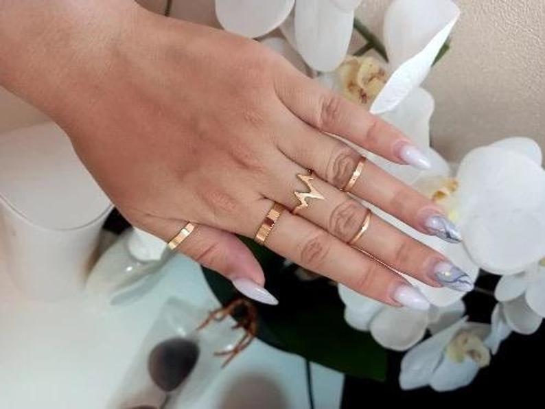 5 Piece Stackable Midi Gold Silver Chevron Knuckle Boho Ring Set displayed elegantly, showcasing the intricate design and color options.