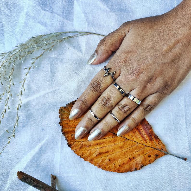 5 Piece Stackable Midi Gold Silver Chevron Knuckle Boho Ring Set displayed elegantly, showcasing the intricate design and color options.