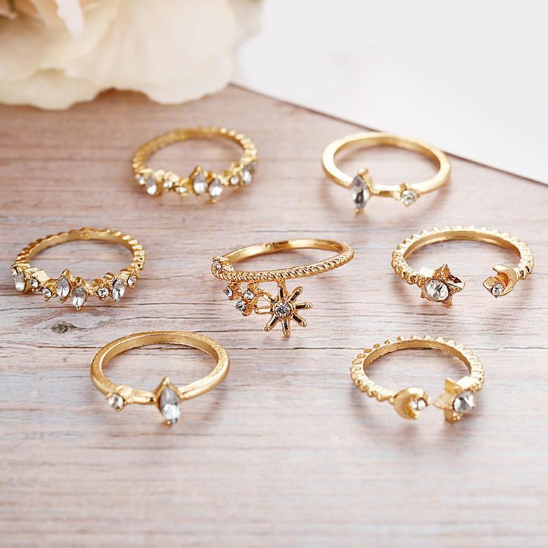 5 Piece Stars Ring Set featuring sparkling crystals and 18K gold plating, elegantly displayed on a soft surface.