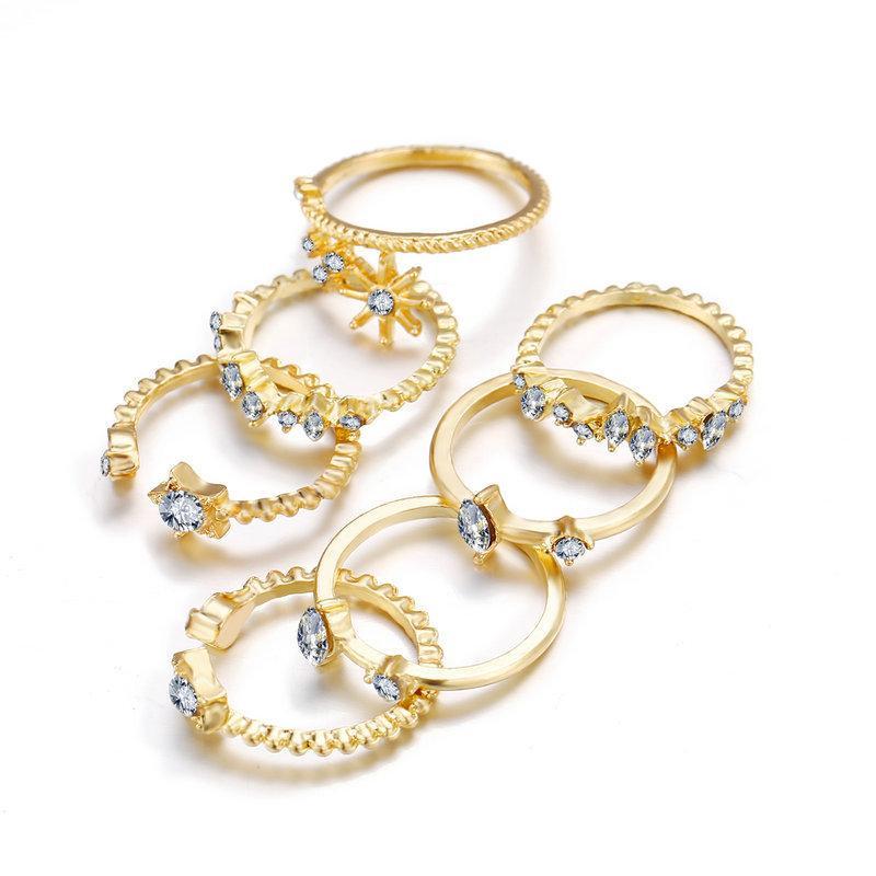 5 Piece Stars Ring Set featuring sparkling crystals and 18K gold plating, elegantly displayed on a soft surface.