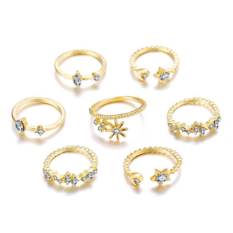 5 Piece Stars Ring Set featuring sparkling crystals and 18K gold plating, elegantly displayed on a soft surface.