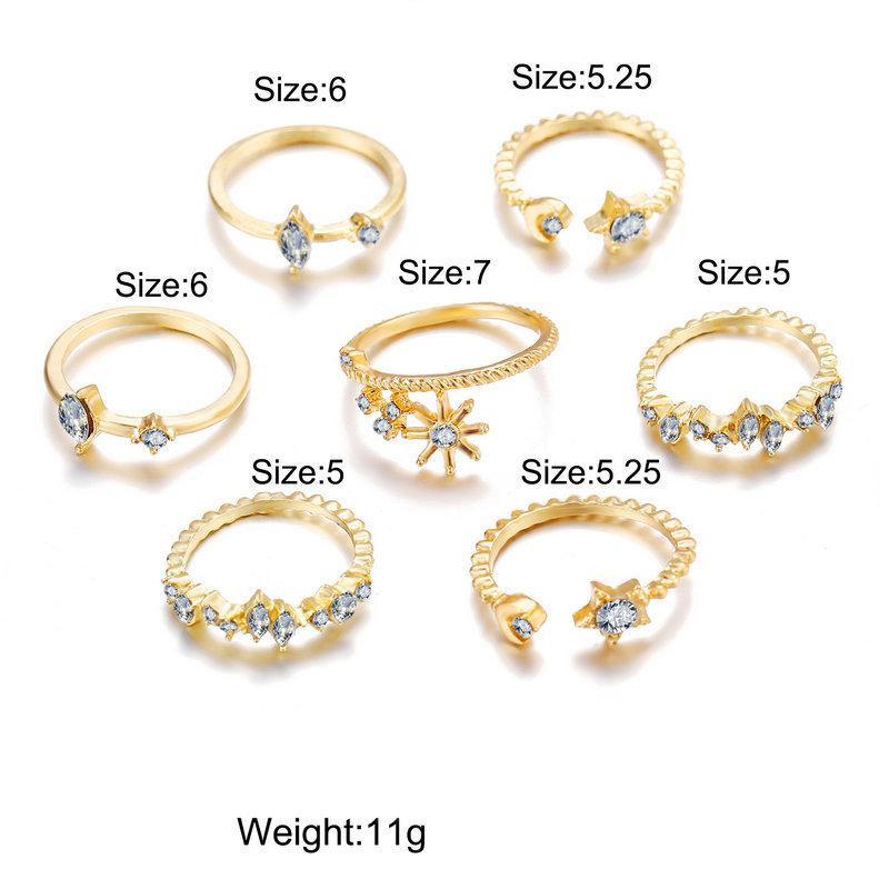 5 Piece Stars Ring Set featuring sparkling crystals and 18K gold plating, elegantly displayed on a soft surface.