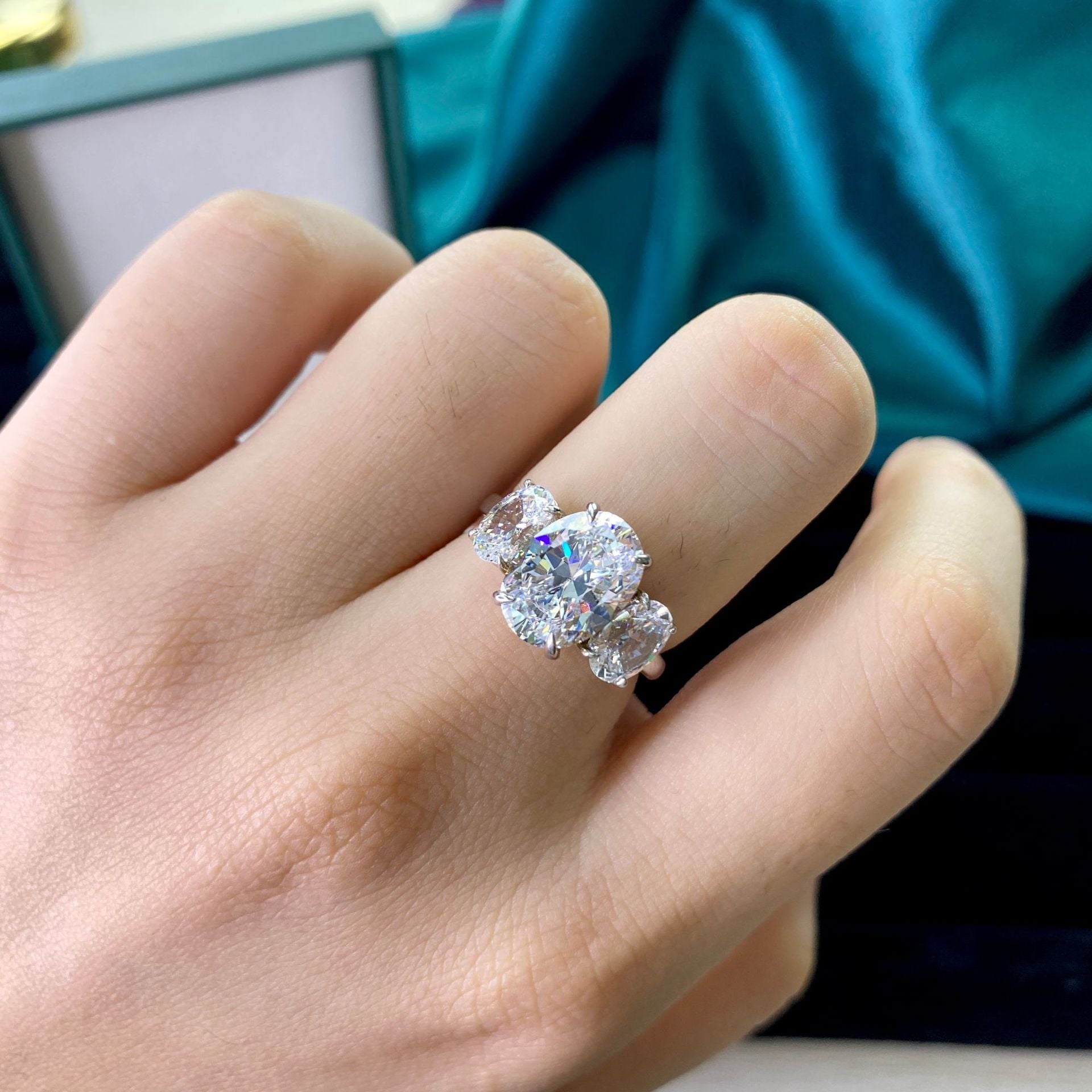 A beautiful 3 stones ring made of 925 sterling silver, featuring three sparkling stones that reflect light brilliantly, showcasing elegance and romance.