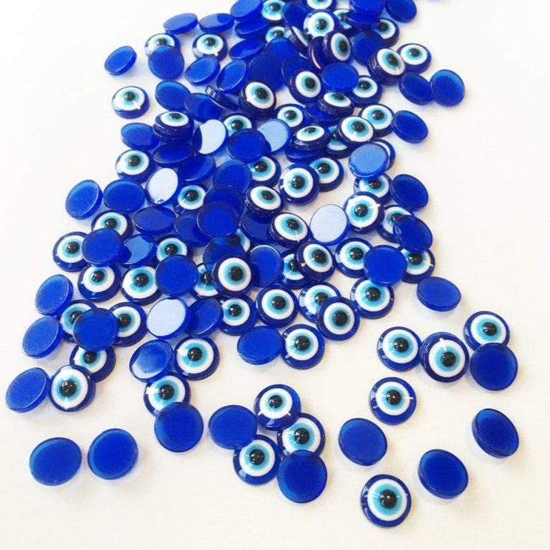 A collection of 500 dark blue evil eye cabochons made from resin, perfect for DIY jewelry and crafts.