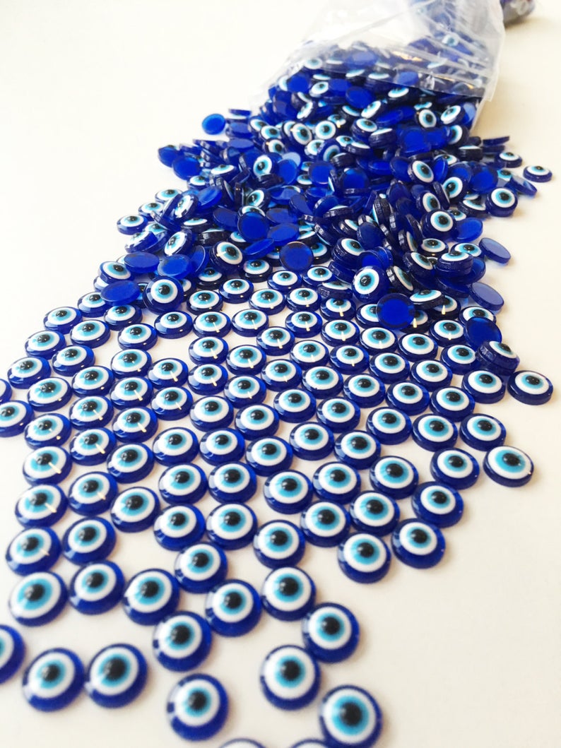 A collection of 500 dark blue evil eye cabochons made from resin, perfect for DIY jewelry and crafts.