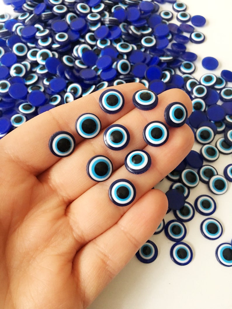 A collection of 500 dark blue evil eye cabochons made from resin, perfect for DIY jewelry and crafts.