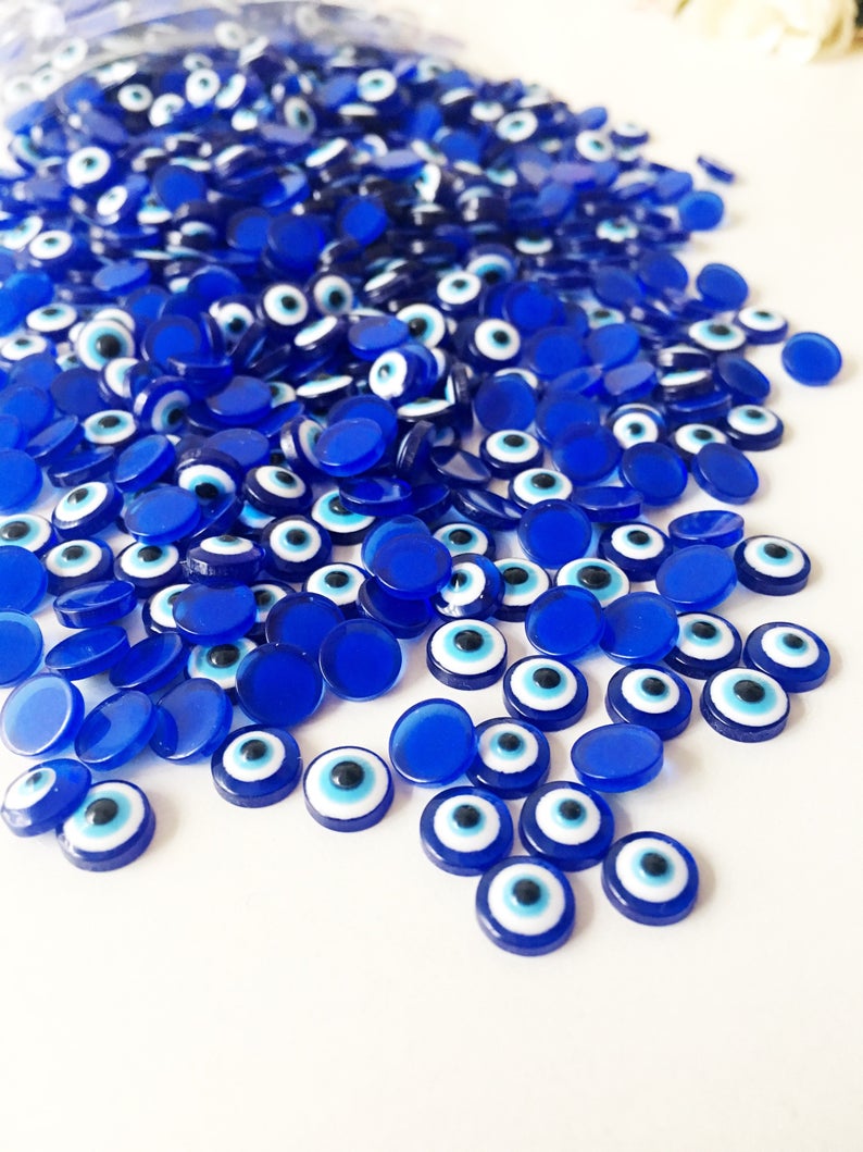 A collection of 500 dark blue evil eye cabochons made from resin, perfect for DIY jewelry and crafts.