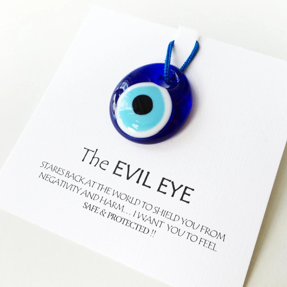 Five unique evil eye wedding favors with beads and personalized cards, symbolizing protection and good luck.