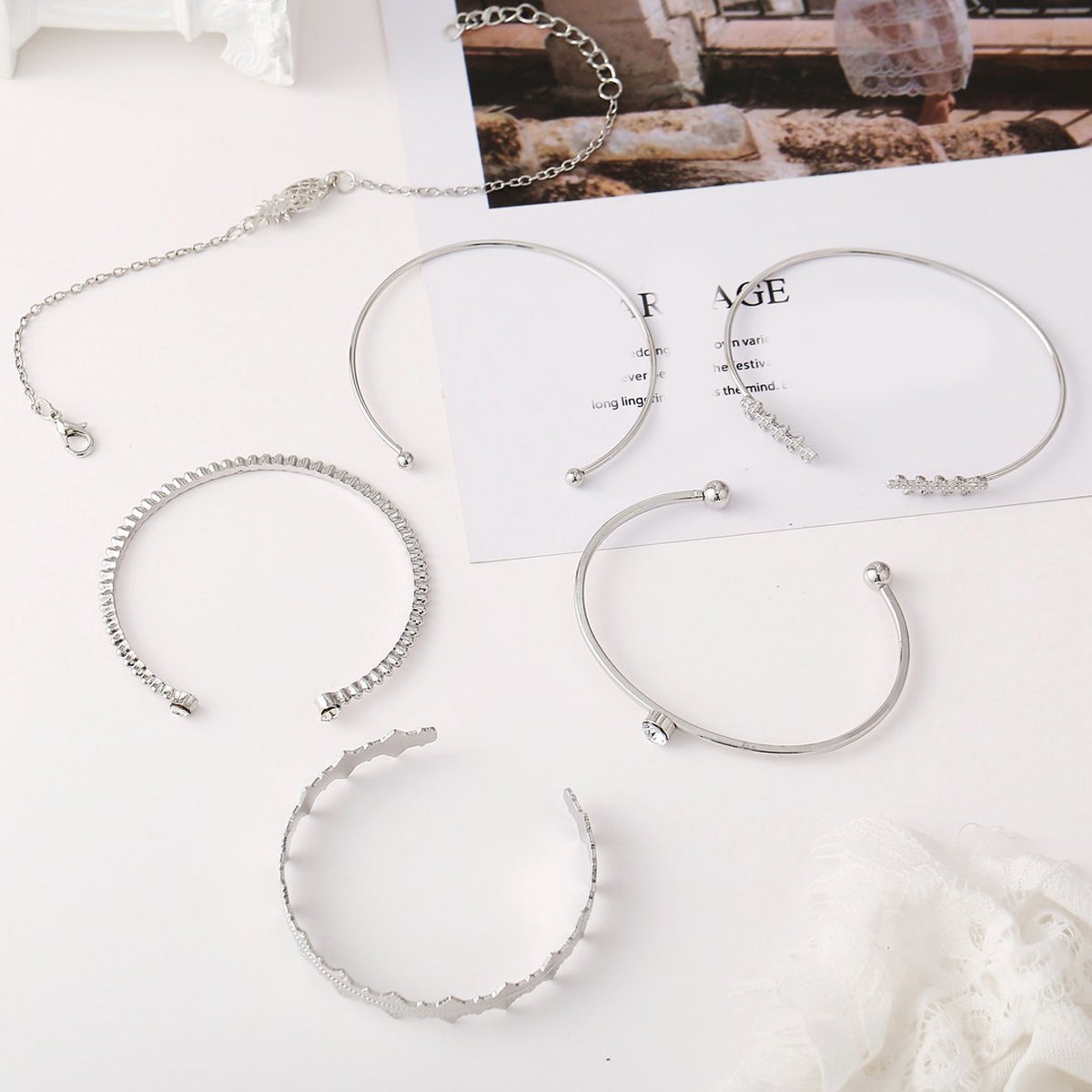 A stunning 6 Piece Geometric Bangle Set featuring Austrian Crystals in 18K White Gold, showcasing intricate designs and a luxurious finish.