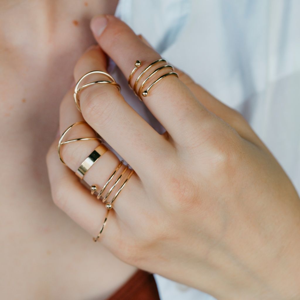 A stylish set of 6 gold and silver boho thumb rings, showcasing intricate designs and a mix of colors, perfect for stacking.