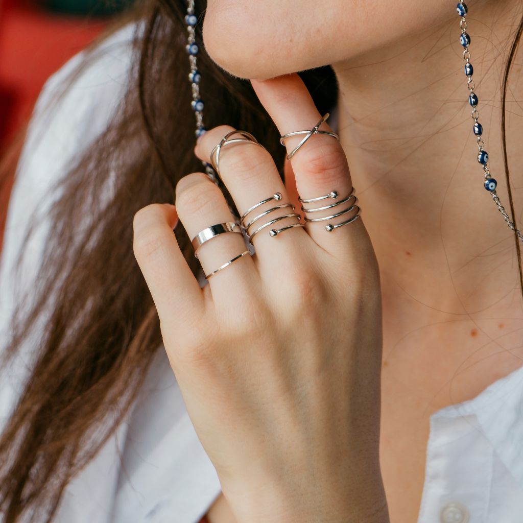 A stylish set of 6 gold and silver boho thumb rings, showcasing intricate designs and a mix of colors, perfect for stacking.