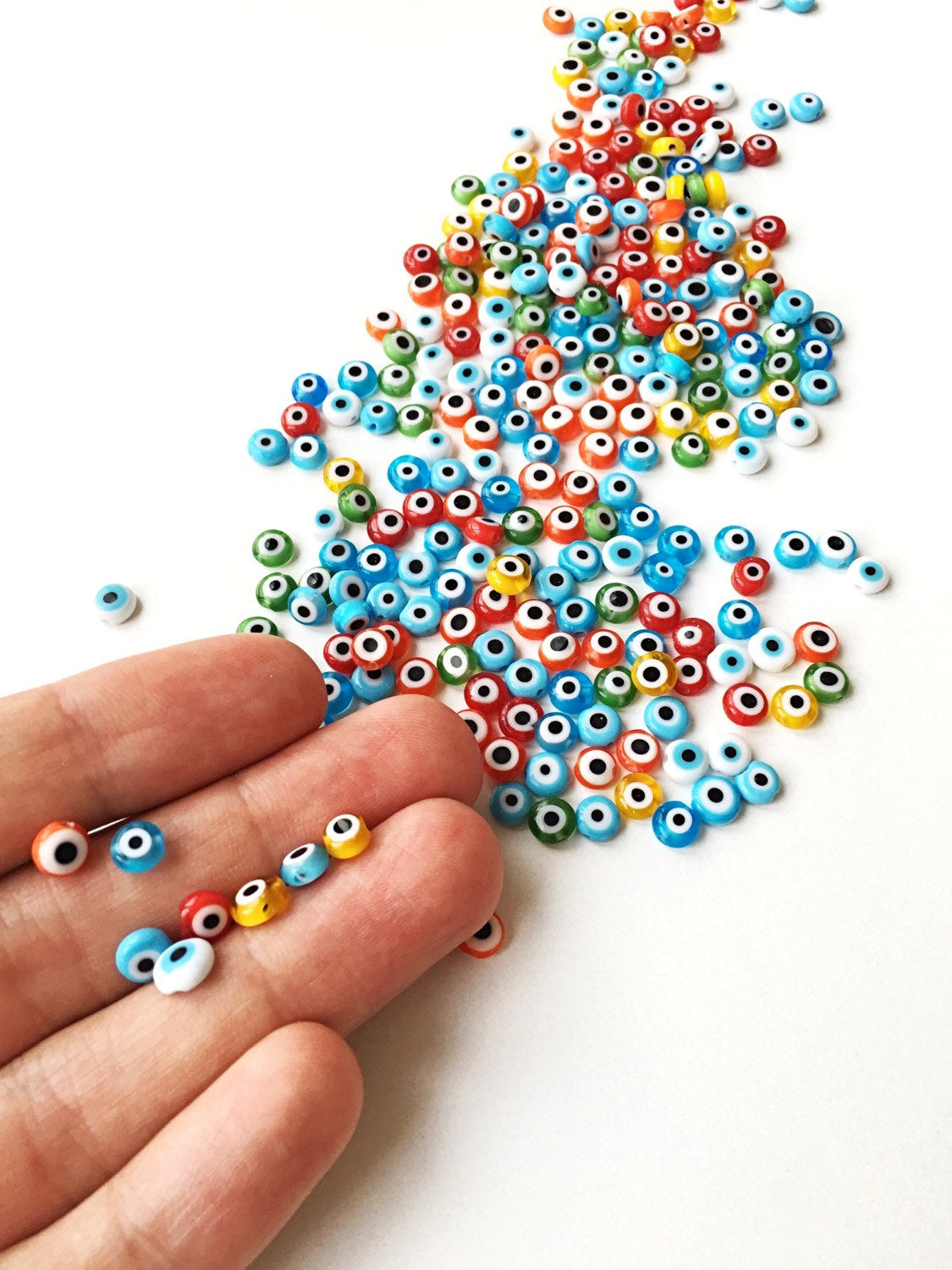 A strand of 6mm Turkish evil eye beads in various colors including red, yellow, green, and blue, showcasing their vibrant designs.