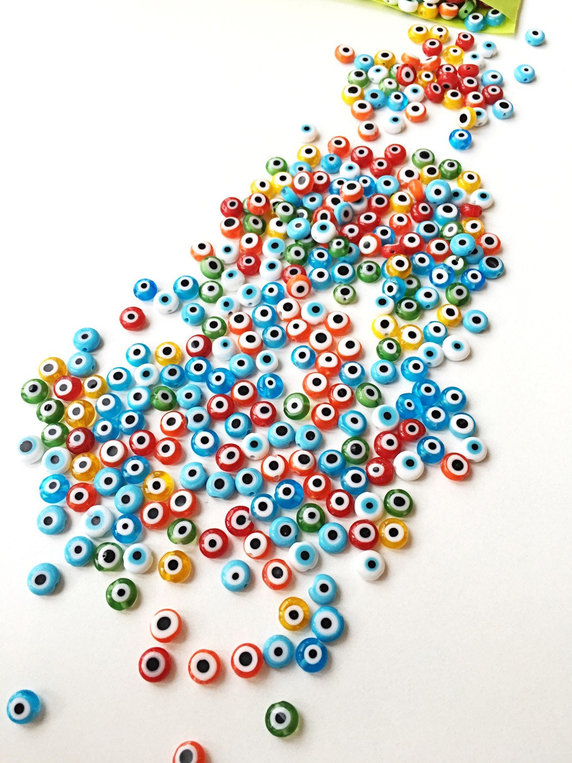 A strand of 6mm Turkish evil eye beads in various colors including red, yellow, green, and blue, showcasing their vibrant designs.