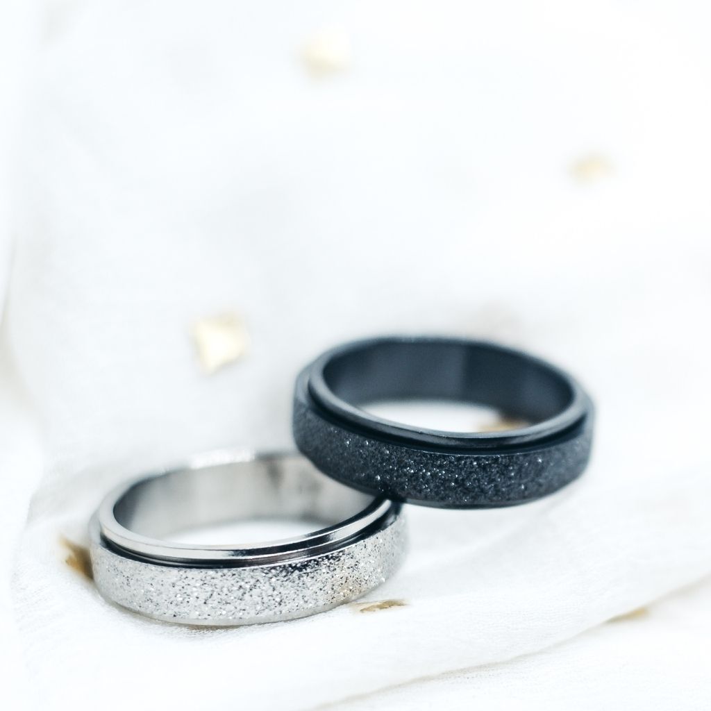 6mm Mens Black Rotatable Spinner Stainless Steel Promise Ring showcasing its sleek black finish and minimalist design.