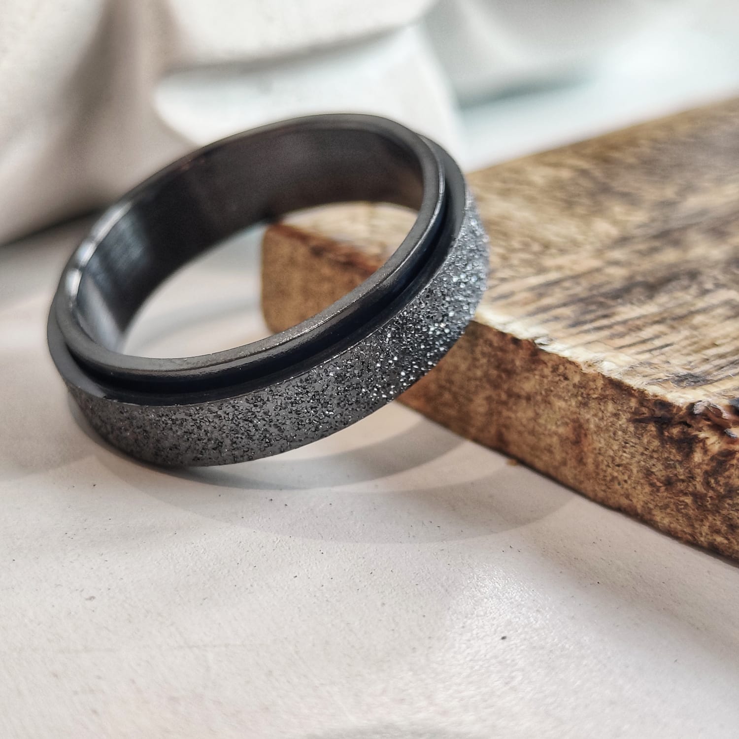 6mm Mens Black Rotatable Spinner Stainless Steel Promise Ring showcasing its sleek black finish and minimalist design.