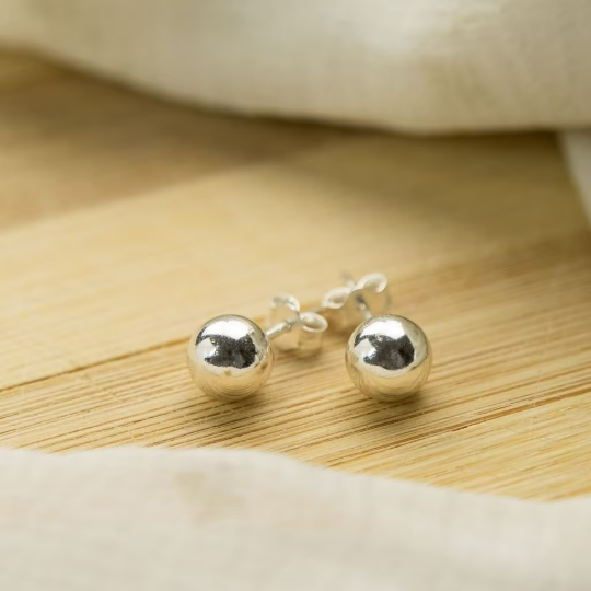 A pair of 6mm pure silver solid unisex round ball dot studs, showcasing their minimalistic and elegant design.