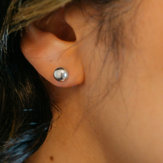 A pair of 6mm pure silver solid unisex round ball dot studs, showcasing their minimalistic and elegant design.