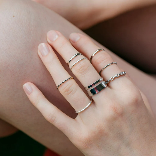 A stylish 7 Piece Multisize Band Silver Cuff Stackable Boho Ring set displayed elegantly, showcasing intricate designs and assorted sizes.