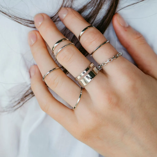 A stylish 7 Piece Multisize Band Silver Cuff Stackable Boho Ring set displayed elegantly, showcasing intricate designs and assorted sizes.