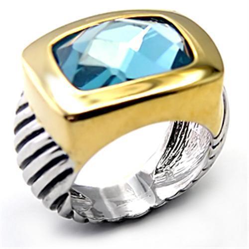 7X119 Reverse Two-Tone Brass Ring featuring a London Blue Spinel, showcasing its elegant design and semi-precious stone.