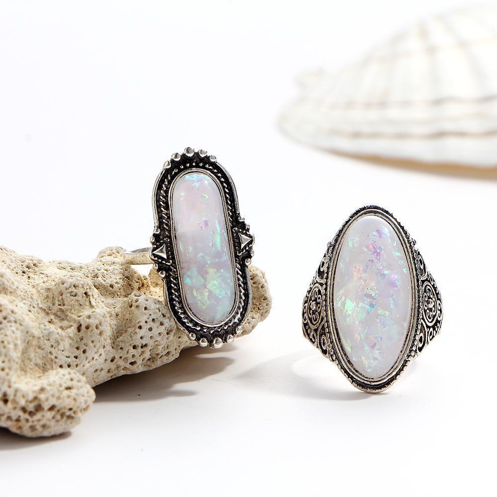 An elegant 8 piece ring set featuring opal created stones and Austrian crystals, beautifully oxidized for a timeless look.