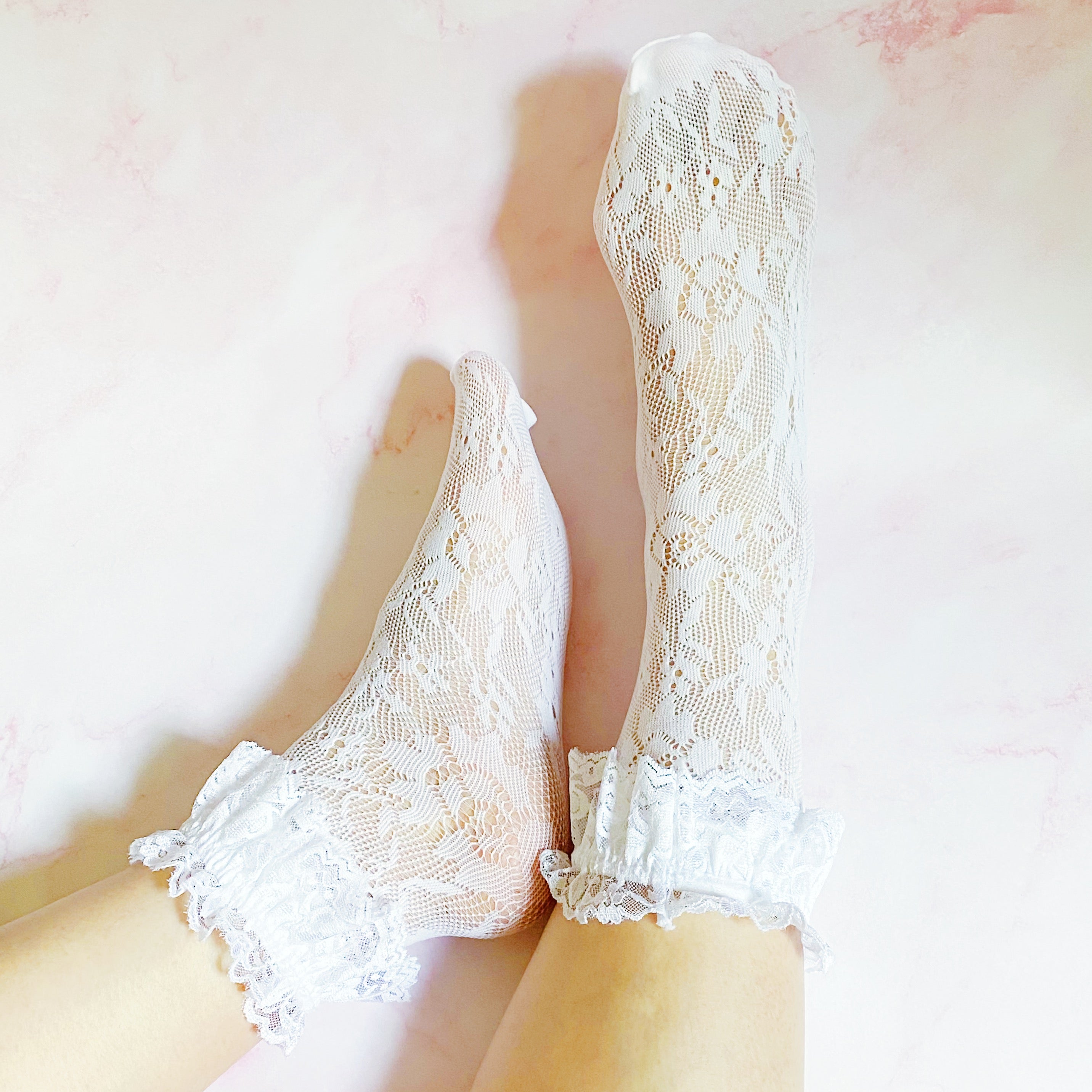 A stylish set of 80's lace socks in two pairs, featuring intricate lace patterns and a doubled layer around the ankle, perfect for vintage fashion lovers.