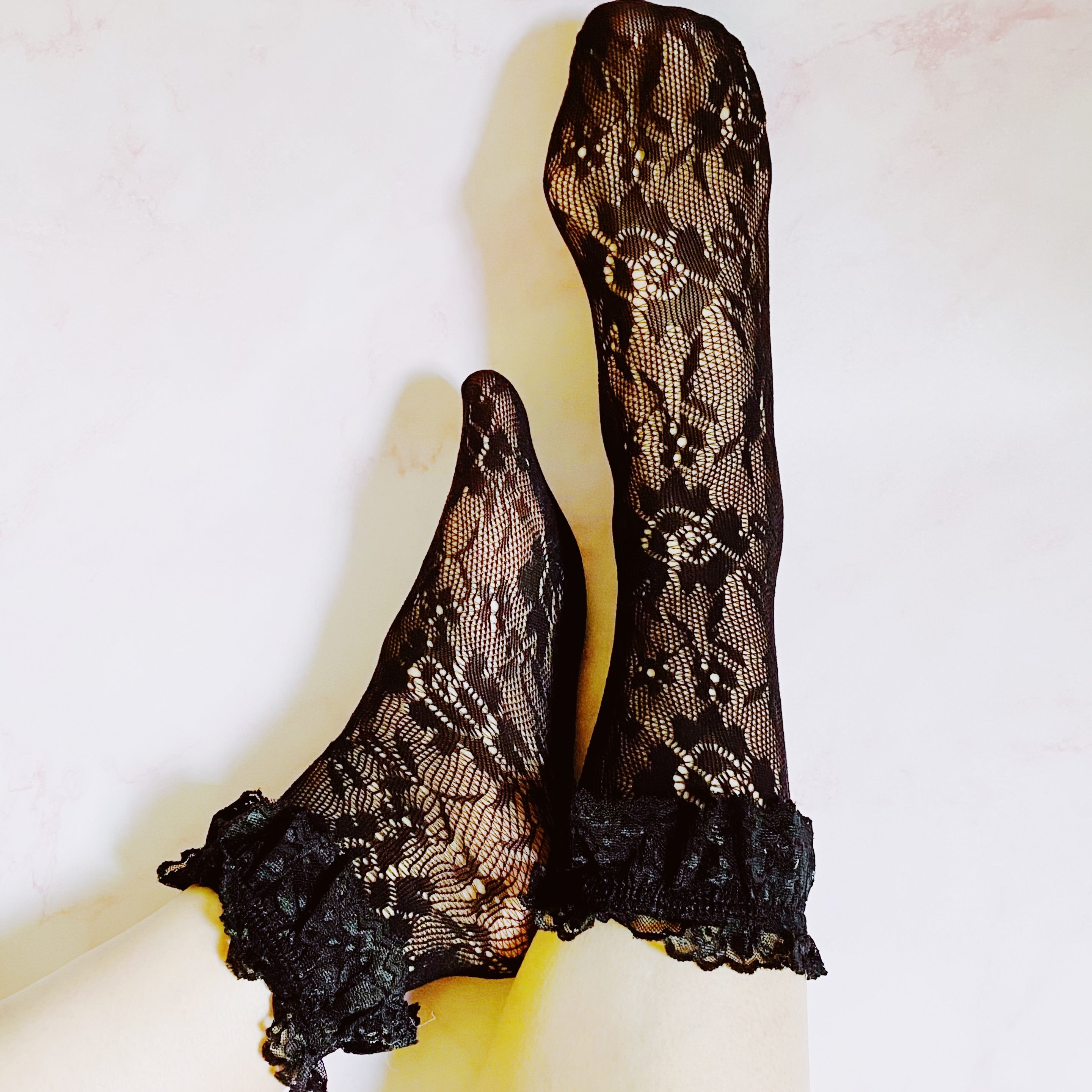 A stylish set of 80's lace socks in two pairs, featuring intricate lace patterns and a doubled layer around the ankle, perfect for vintage fashion lovers.