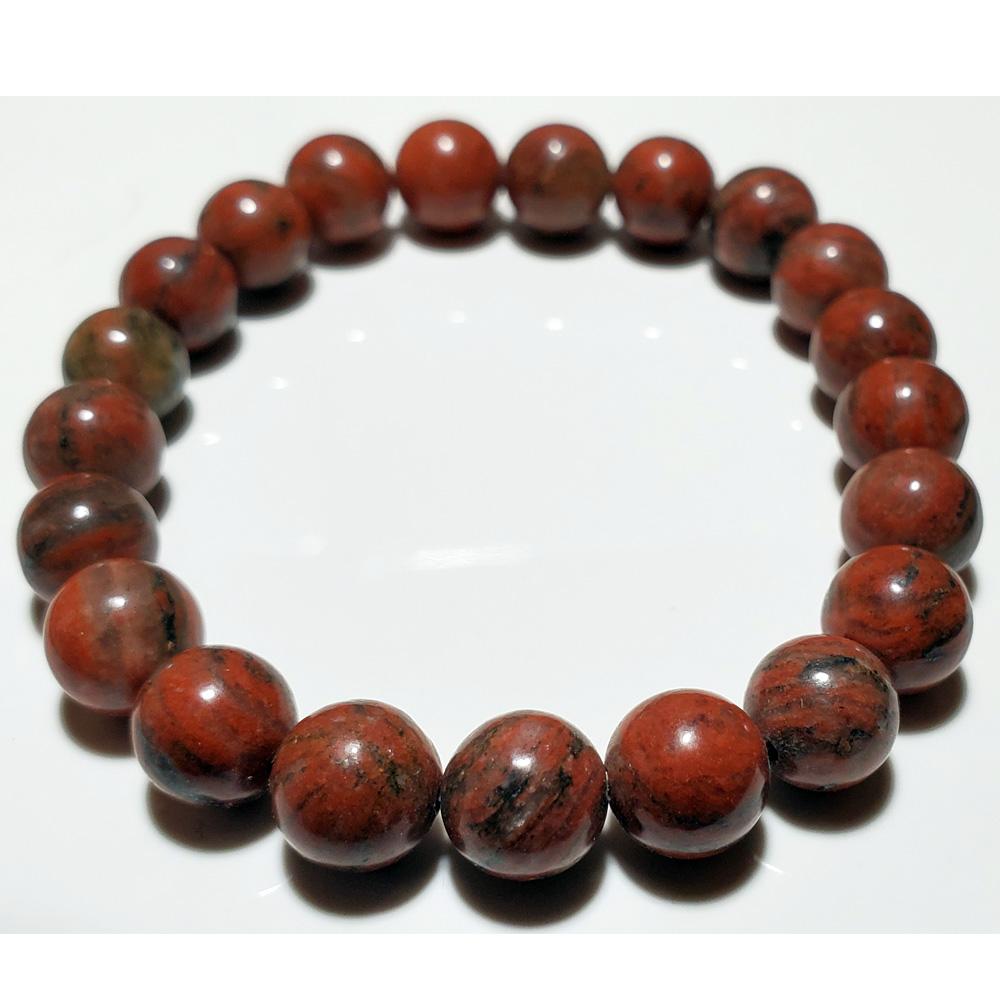 A close-up of an 8mm red jasper beaded elastic stretch bracelet, showcasing its smooth finish and vibrant color.