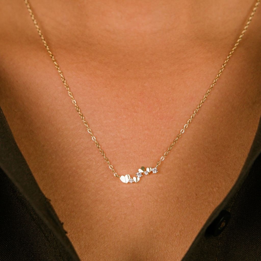 A delicate 925 Sterling Silver necklace featuring a tiny heart pendant adorned with sparkling zirconia, showcasing elegance and charm.