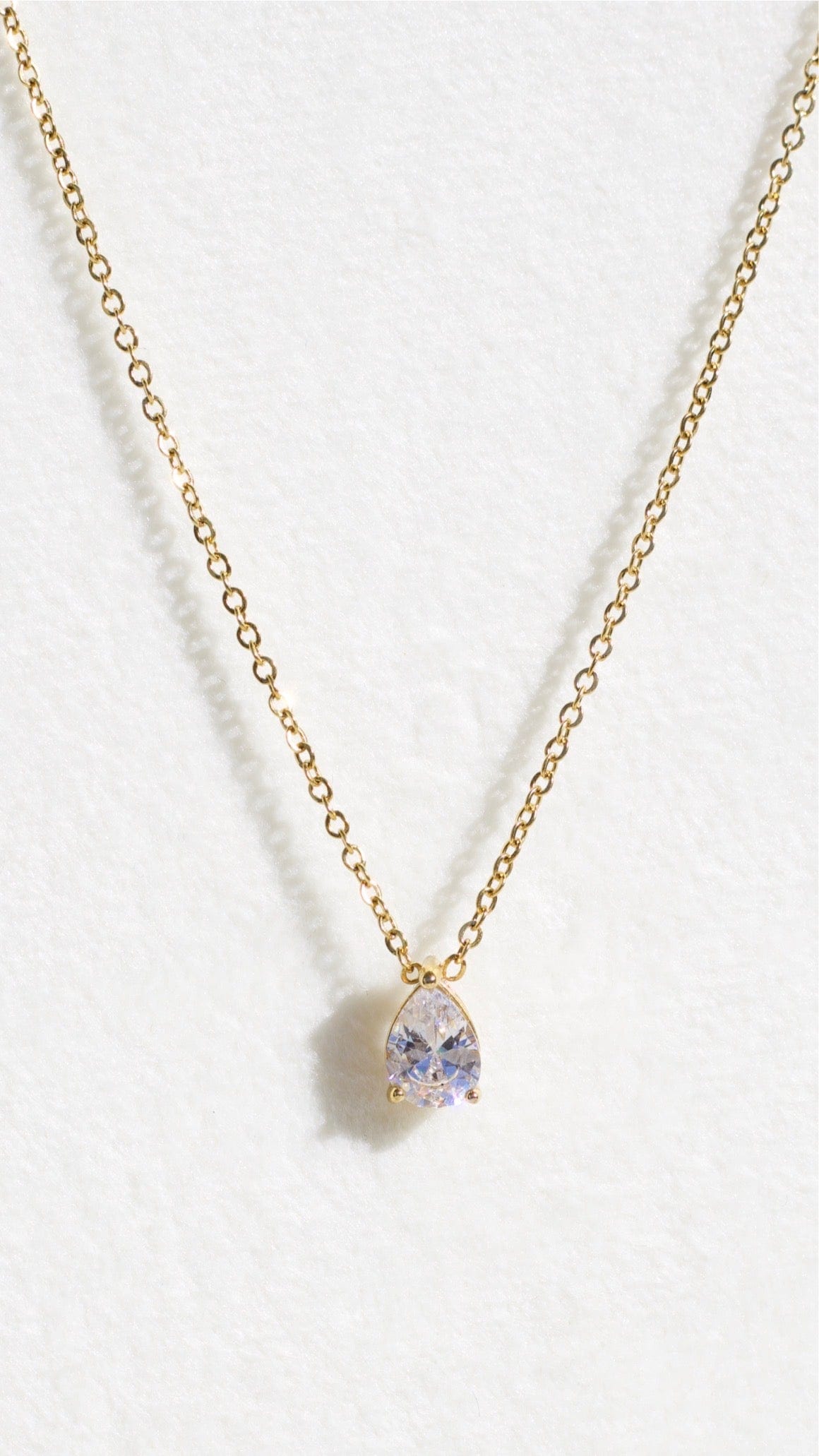 Abboid Drop Necklace featuring diamond-shaped charms and cubic zircon crystals, elegantly designed with 18Kt yellow gold coating.