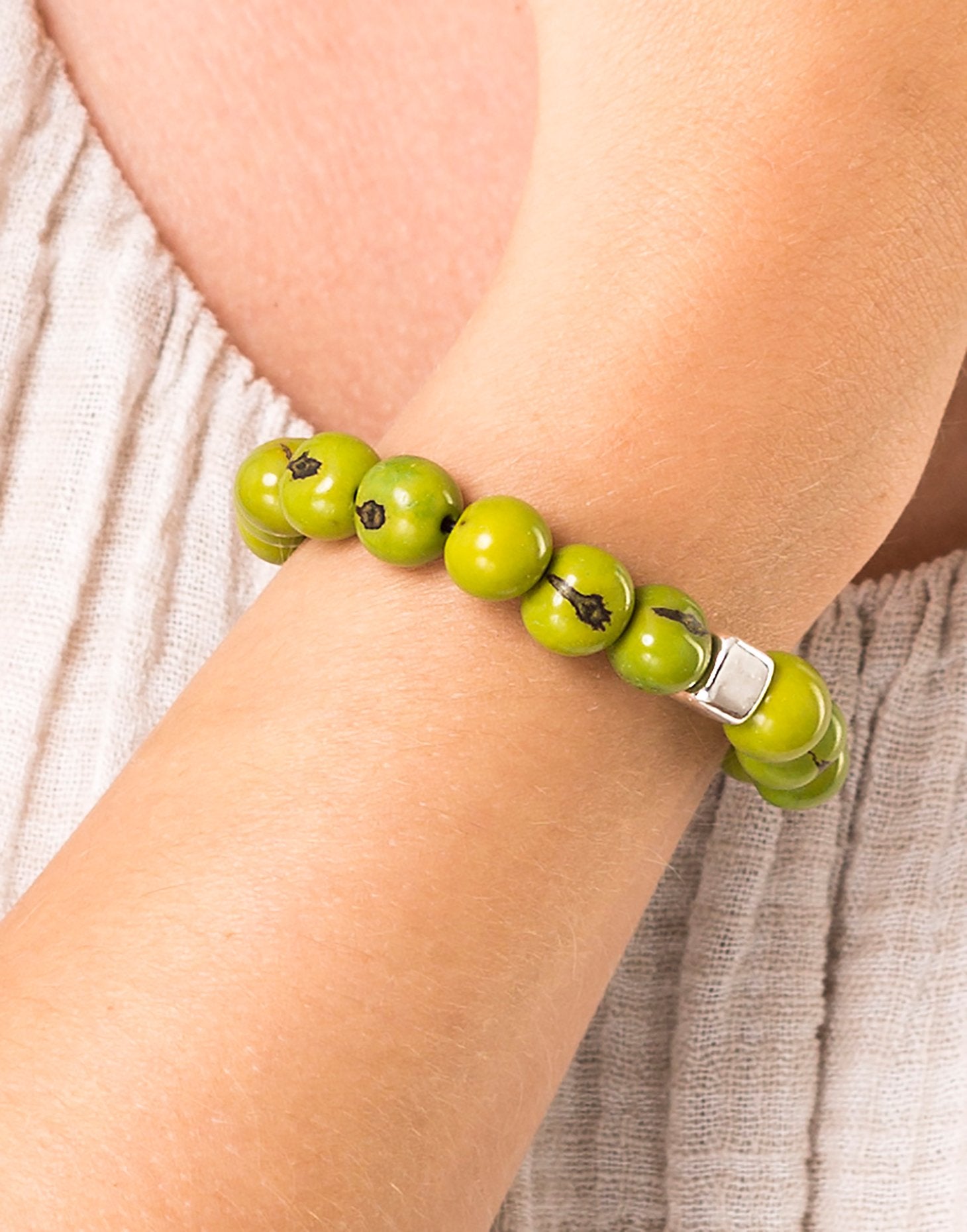 A collection of vibrant Acai Berry Bracelets featuring cool colours, silver plated cubes, and elasticated bands, showcasing their unique design.