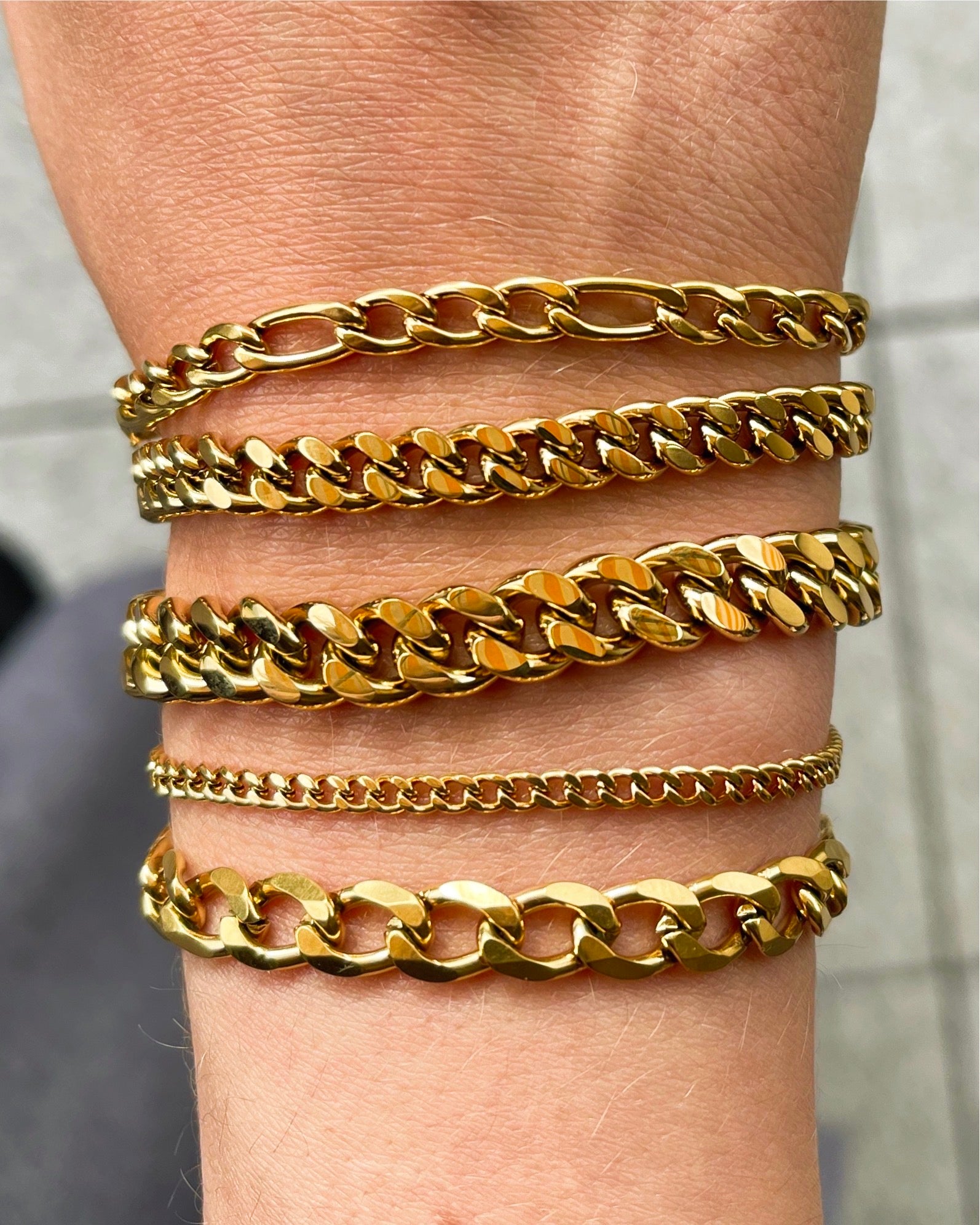 Acco Cuban Link Bracelet in gold and silver, showcasing its elegant design and durable materials.