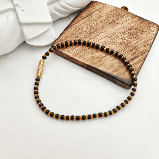 Adjustable Black Golden Beads Nazaria Bracelet featuring evil eye charm, designed for newborns and kids, showcasing a chic black and golden color scheme.