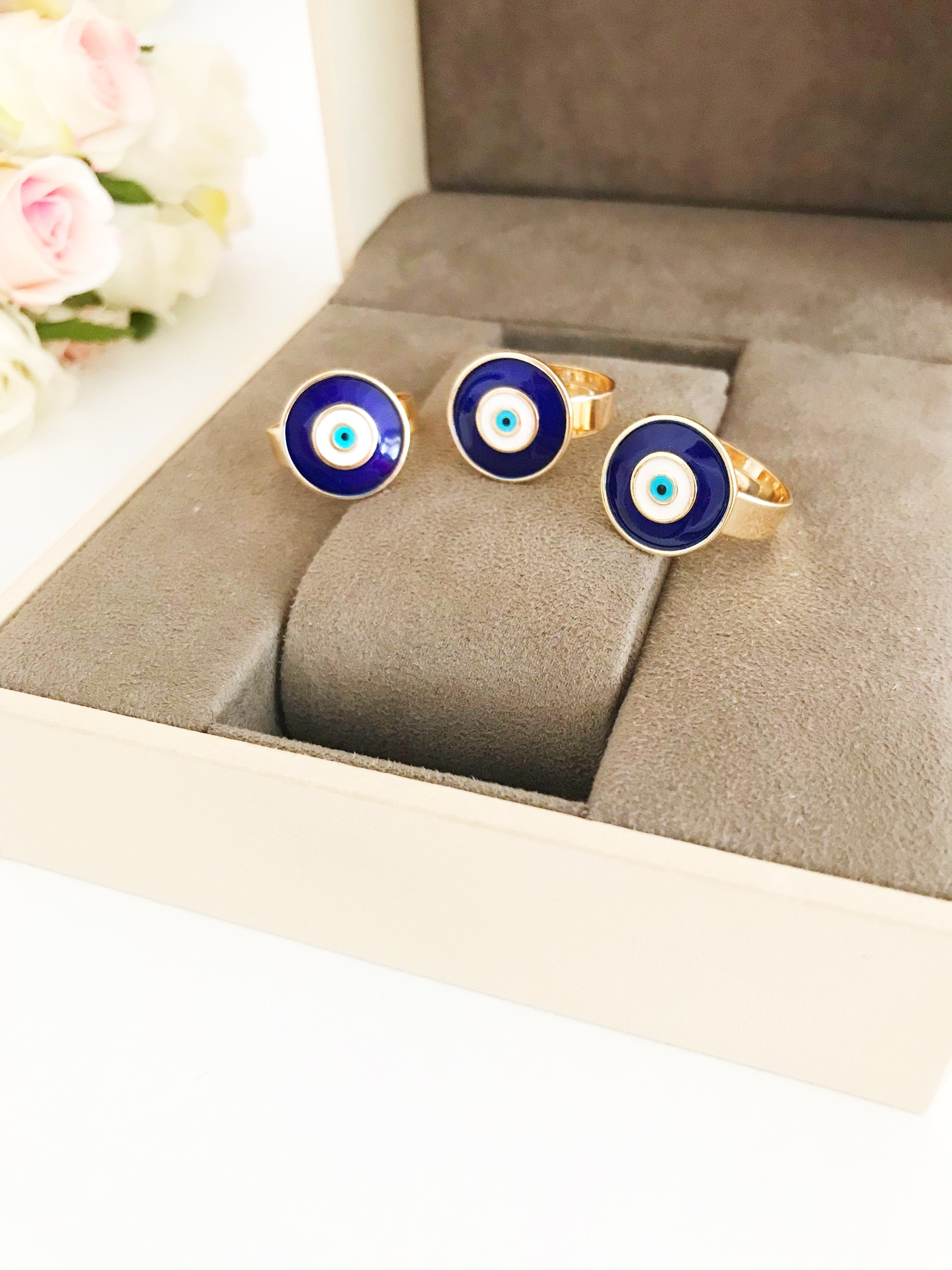 Adjustable blue evil eye ring featuring a round eye design, symbolizing protection and good luck, crafted for comfort and style.